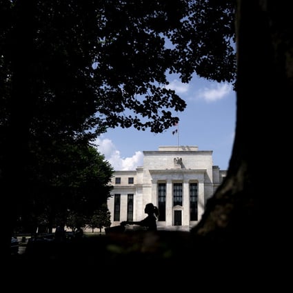 A cyclist rides past the Federal Reserve building in Washington on June 20. Fed chair Jerome Powell told Congress last week that the Fed would wait for “actual evidence of actual inflation” before increasing rates – a monetary policy equivalent of leaving the door to a stable of expensive racehorses wide open. Photo: Bloomberg