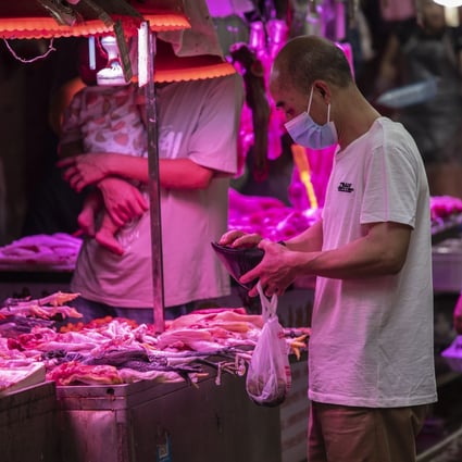 Chinese shop at an open-air market in Guangzhou on May 24. Pork is central to Chinese cuisine and culture. Photo: Bloomberg