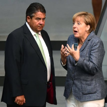 German Chancellor Angela Merkel (right) talks with then German vice-chancellor Sigmar Gabriel during a debate ahead of a vote on a third bailout for debt-mired Greece at the German lower house of parliament in Berlin in August 2015. Photo: AFP 