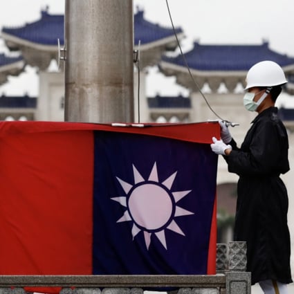 Taiwanese honour guards fold the island’s flag in Taipei on June 22. Photo: EPA-EFE