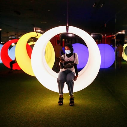 A woman sits on an art installation at Trans Studio in Jakarta, Indonesia. Photo: Reuters