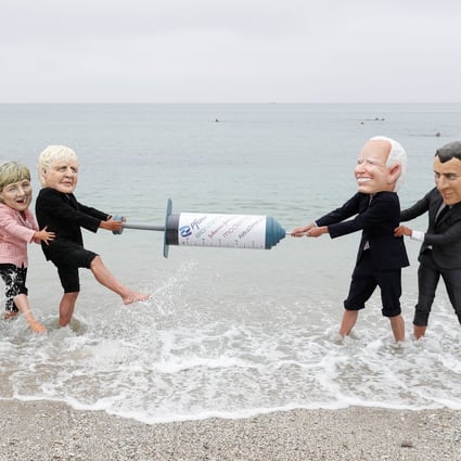 Oxfam activists wearing “big head” caricatures of G7 leaders pretend to fight over a Covid-19 vaccine during a beach-side protest on the sidelines of the Group of Seven summit, in Cornwall, Britain, on June 11. Photo: Reuters
