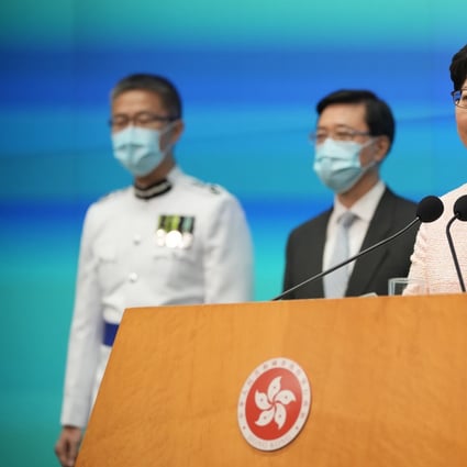 Hong Kong’s Chief Executive Carrie Lam speaks as new Chief Secretary John Lee, centre, and new Commissioner of Police Raymond Siu Chak-yee look on, during a news conference in Hong Kong on June 25. Photo: AP  