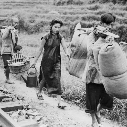 Chinese civilians burdened with household goods flee from the advancing Japanese troops in Eastern China in 1944. Photo: Getty Images