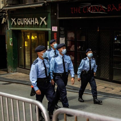 Hong Kong police officers patrol the party district of Lan Kwai Fong in Central on Christmas Eve. Photo: AFP