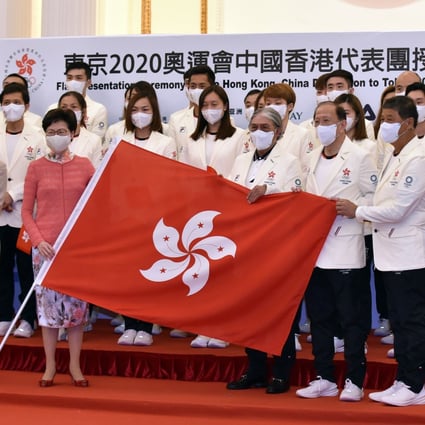 Hong Kong’s Chief Executive Carrie Lam Cheng Yuet-ngor (in pink blouse, first row) and sports chief Timothy Fok Tsun-ting (first row, third right)  pose with members of the Hong Kong delegation during a flag presentation ceremony for the Tokyo Olympic Games, at Government House on July 8. Photo: Xinhua 