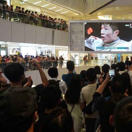 Hong Kong fans watching on a giant screen at a shopping mall cheer Edgar Cheung’s victory against Garozzo Daniele of Italy in the men’s individual foil finals in fencing at the Tokyo Olympic Games on July 26. Photo: Winson Wong