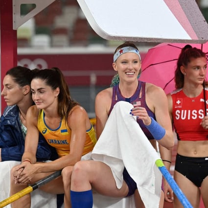 Track athletes shelter from the rain during the women’s pole vault qualification during the Tokyo 2020 Olympic Games at the Olympic Stadium in Tokyo on August 2. Women athletes should be able to wear what they feel most comfortable competing in. Photo: AFP