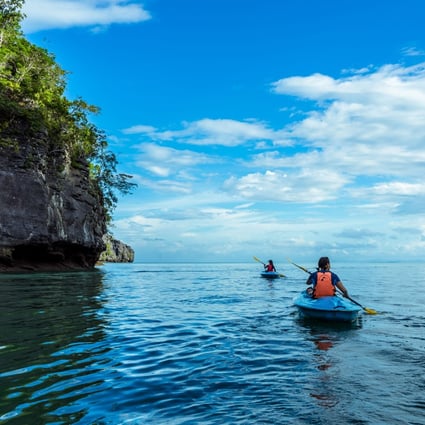 Tourists explore one of Langkawi’s many jungle-clad islands by kayak. Photo: courtesy of Dev’s Adventure Tours