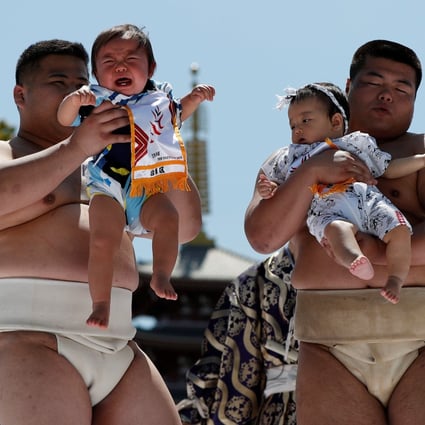 Amateur sumo wrestlers at a baby crying contest at Sensoji temple in Tokyo, Japan. Photo: Reuters