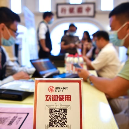 A man signs up to pay with the e-yuan, China’s digital currency, at an expo in Hainan on May 8. Photo: Xinhua