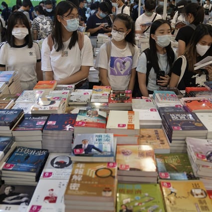 People browse at a booth during the annual Hong Kong Book Fair on July 17. International meetings, conferences and exhibitions brought 2.3 million visitors to Hong Kong in 2018. Photo: AP