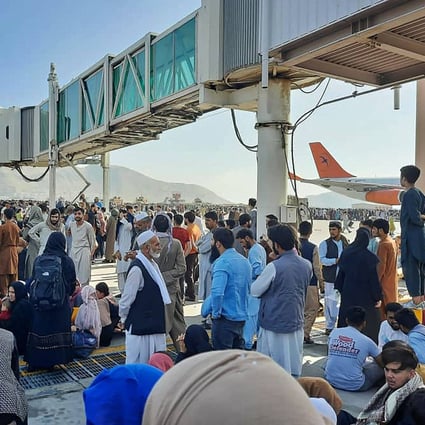Afghans crowd the tarmac at Kabul airport on Monday as they seek to flee the country after the Taliban took control. Photo: AFP
