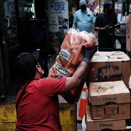 A worker unloads food in the Queens borough of New York City on June 4. Average wage-earners’ salaries have failed to keep up with inflation. Photo: AFP