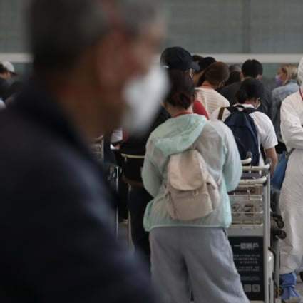 Passengers queue up at the arrival hall of Hong Kong airport on August 19. The Hong Kong government tightened quarantine requirements for people arriving from 16 places, throwing many travel plans into disarray. Photo: Xiaomei Chen