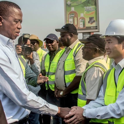 Then Zambian president Edgar Lungu (left) meets Chinese workers from the Aviation Industry Corporation of China, in Lusaka, Zambia, on September 15, 2018. Lungu’s party has been accused of failing to fight for Zambian interests in its dealings with China. Photo: AFP