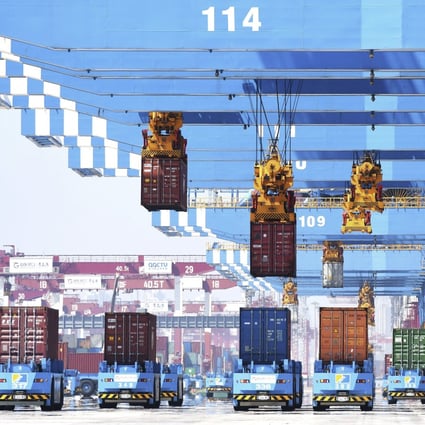 Gantry cranes move containers onto transporters at a port in Qingdao in eastern China’s Shandong province, on June 4. Photo: AP