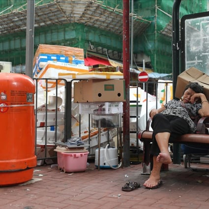 A woman sleeps on a bench in front of cardboard and styrofoam waste and a rubbish bin in To Kwa Wan on September 23, 2020. Where is the legislation to regulate overpackaging and the removal of the most harmful plastic pollutants, such as styrofoam? Photo: Xiaomei Chen