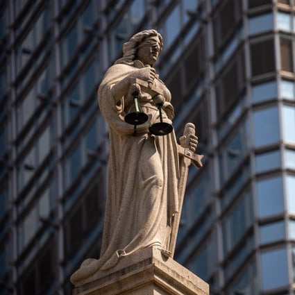A statue of Lady Justice sits on top of the Court of Final Appeal in Hong Kong’s Central district. The fundamental rights guaranteed by Article 35 of the Basic Law include access to the courts and the right to institute legal proceedings against the acts of the executive authorities. Photo: EPA-EFE