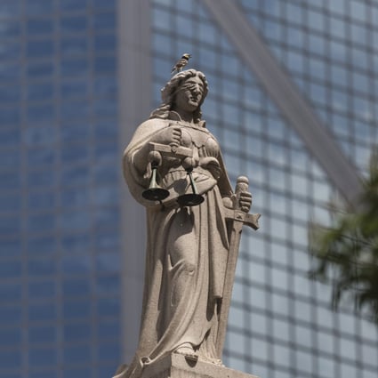 A statue of Lady Justice sits atop the Court of Final Appeal building in Central, Hong Kong, on July 4, 2018. Photo: EPA-EFE