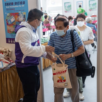 A man receives a free bag of rice after getting a Covid-19 vaccine shot at a shopping mall in Hong Kong on September 2. The Link Reit, which owns the shopping centre, organised the initiative with the government to boost vaccination rates in the city. Photo: EPA-EFE