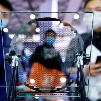 Visitors study a semiconductor display at the Semicon China trade fair in Shanghai, on March 17. The huge sums Beijing has ploughed into the sector have resulted in spectacular failures and the emergence of thousands of new companies that have no technological expertise but wish to capitalise on the subsidies. Photo: Reuters