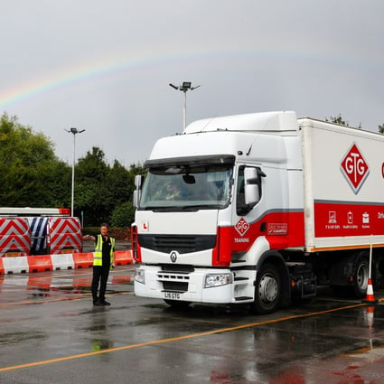 A heavy goods vehicle driving instructor directs a student in Wolverhampton, Britain. Photo: Bloomberg