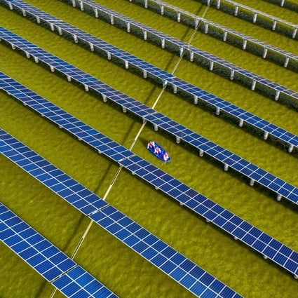 Electrical workers in a boat check solar panels at a photovoltaic power station built in a fishpond in Haian, eastern Jiangsu province, on July 19. Photo: AFP