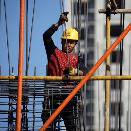 A man works on scaffolding at a construction site of a residential compound in Beijing on October 19, 2020. After an impressive rebound following the first wave of Covid-19, housing sales have weakened. Photo: Reuters