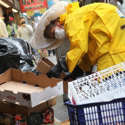 An elderly woman collects cardboard boxes on a street in Mong Kok in February 2020. It is no longer acceptable to protect businesses while allowing those who have worked hard their entire lives, but still do not have a basic standard of living, to continue to suffer. Photo: K. Y. Cheng