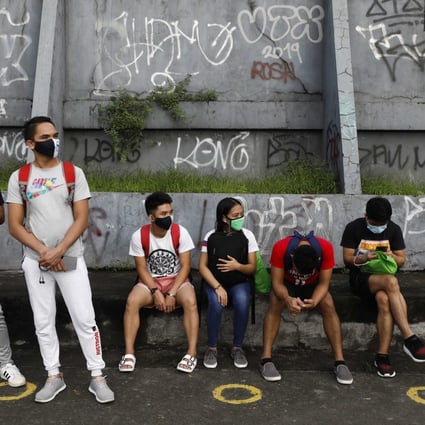 Young people wait for a ride at a public transport stop in Quezon City, the Philippines, on November 10, 2020. Youth unemployment in the country hit 22 per cent last year. Photo: EPA-EFE