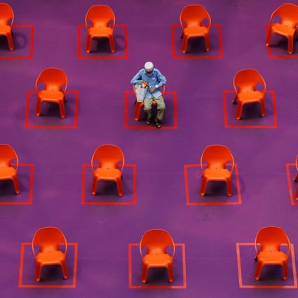 A man sits among empty seats at a free movie screening in Singapore, on September 29, as restrictions on social gathering are tightened due to the surge of Covid-19 cases. Photo: Reuters