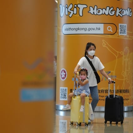 A woman and child walk past a Visit Hong Kong tourism poster at the port at the Hong Kong-Zhuhai-Macao Bridge on September 15. Photo: Sam Tsang