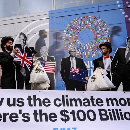 Activists dressed as debt collectors hold cutouts of world leaders during a demonstration at the International Monetary Fund headquarters to ask rich nations to keep their commitment to support developing countries in tackling climate change, in Washington on October 13. Photo: AFP