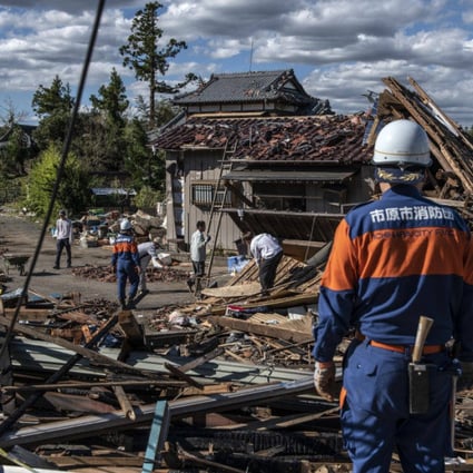 Search and rescue crews sort through the debris of a building in Chiba, Japan, destroyed by a tornado in 2019 shortly before the arrival of Typhoon Hagibis, one of the most powerful storms in decades to strike the country. Photo by Carl Court/Getty Images