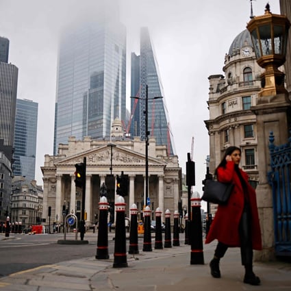 A pedestrian walks near the Royal Exchange and the Bank of England in the City of London on December 28, 2020. The central bank’s chief economist has warned that UK inflation is likely to hit or surpass 5 per cent by early next year. Photo: AFP