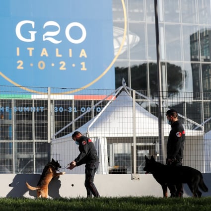 Police officers inspect the area with dogs trained to detect explosives, outside the La Nuvola convention centre, ahead of the Group of 20 summit in Rome, on October 27. Photo: Reuters