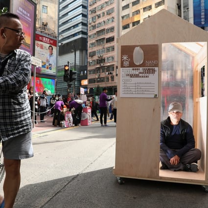A nano-flat exhibit organised by the Hong Kong Platform Concerning Subdivided Flats attracts attention in a pedestrian zone in Causeway Bay on January 20, 2019. Photo: Nora Tam