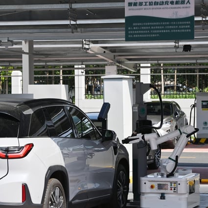 A charging robot for electric cars operates at the Jinmenhu New Energy Vehicle Integrated Service Centre in Tianjin on August 18. Chinese-made electric vehicles are poised to swamp international markets. Photo: Xinhua