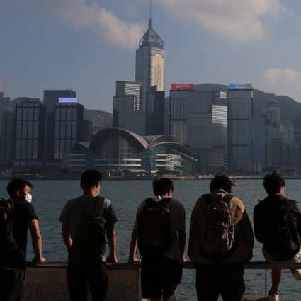 Young people look across Victoria Harbour from the Tsim Sha Tsui promenade on November 1. Hong Kong’s Basic Law, which came into force in 1997, states that the city’s “previous capitalist system and way of life shall remain unchanged for 50 years”. Photo: Felix Wong