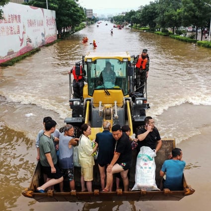Residents being evacuated from flood-hit Xinxiang in China’s Henan province. Photo: AFP