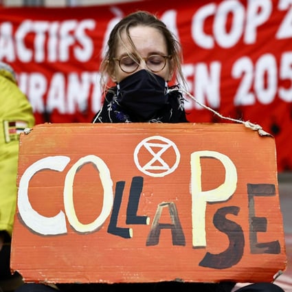 A climate activist holds a placard during a protest organised by Extinction Rebellion to denounce the lack of measures against climate change ahead of COP26 summit in Paris on October 31. Photo: Reuters 