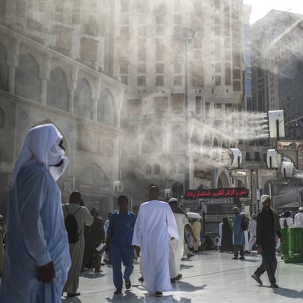 Water is sprayed over Muslim pilgrims to cool them down during the afternoon heat as they walk outside the Grand Mosque in the holy city of Mecca, Saudi Arabia. With a climate that is already among the hottest on earth, Saudi Arabia has reason to fight global heating. Photo: AP