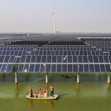 Electricity workers patrol a solar and wind power farm in Sheyanghu, Baoying county, in Jiangsu province, on November 3. Photo: Xinhua
