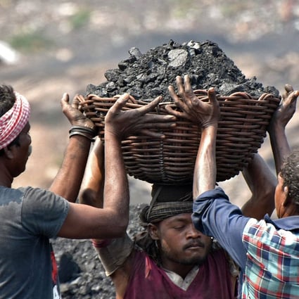 Workers prepare to load coal onto a truck at the Jharia coalfield in Dhanbad, in India’s Jharkhand state, on October 14. India has one of the world’s largest reserves of coal and is the second-largest importer of the fossil fuel, yet it is in crisis. Photo: AFP