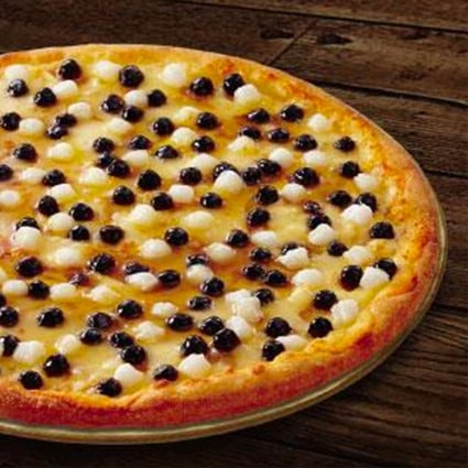Pizza with black sugar pearls, a Taiwanese invention, is among the many novel offerings from pizza companies in Asia. Durian, bananas, sweet potato and spaghetti all feature. 