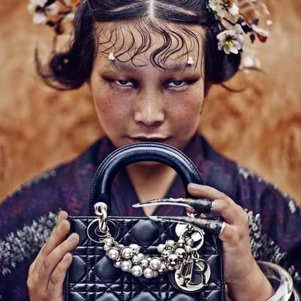 The photo by Chinese photographer Chen Man that Dior has removed from display, showing a woman in traditional Chinese costume holding a Lady Dior bag.