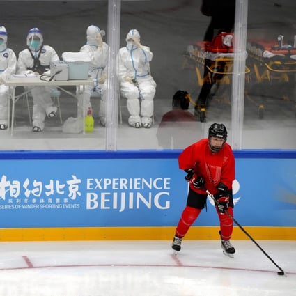 Medical personnel in protective suits watch as the China Ice Sports College hockey team practices during the Experience Beijing ice hockey domestic test activity, a test event for the 2022 Beijing Winter Olympics, at the National Indoor Stadium in Beijing, on November 10. Photo: AP 