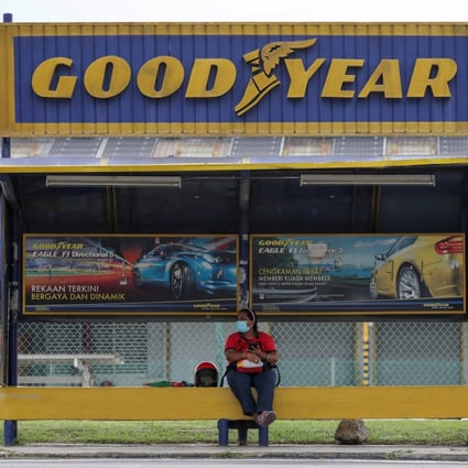 A person sits at a bus stop outside a Goodyear factory in Shah Alam, Malaysia. File photo: Reuters