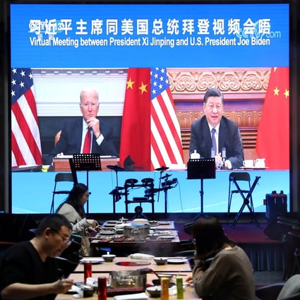 A screen at a Beijing restaurant shows Chinese President Xi Jinping attending a virtual meeting with US President Joe Biden via video link. Photo: Reuters